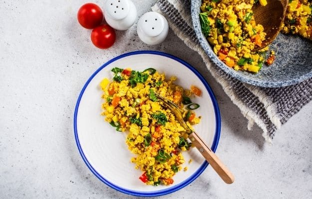 Tofu scramble with vegetables in white plate | Simple Tofu Scramble | 9 Easy Frozen Vegan Meals To Make Ahead